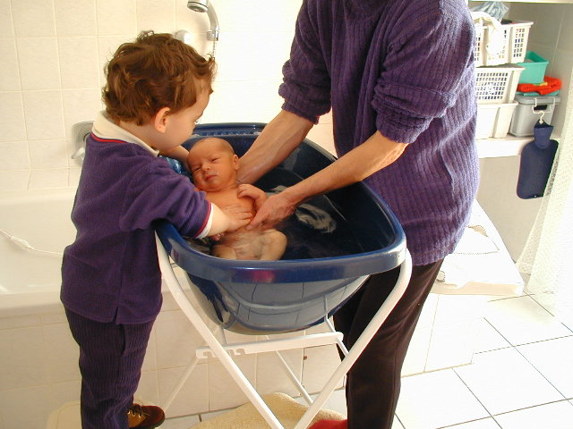 [Nicolas helps with Marcus' first bath, 16 Jan 2001]