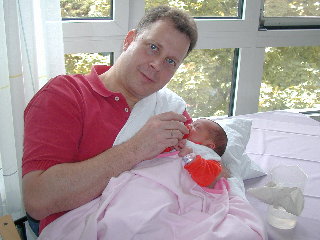 [Dad feeds Marie (two days old) for the first time, 26 June 2004]